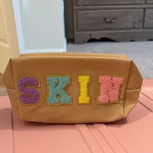 Colorful Lettered Tan Pouch